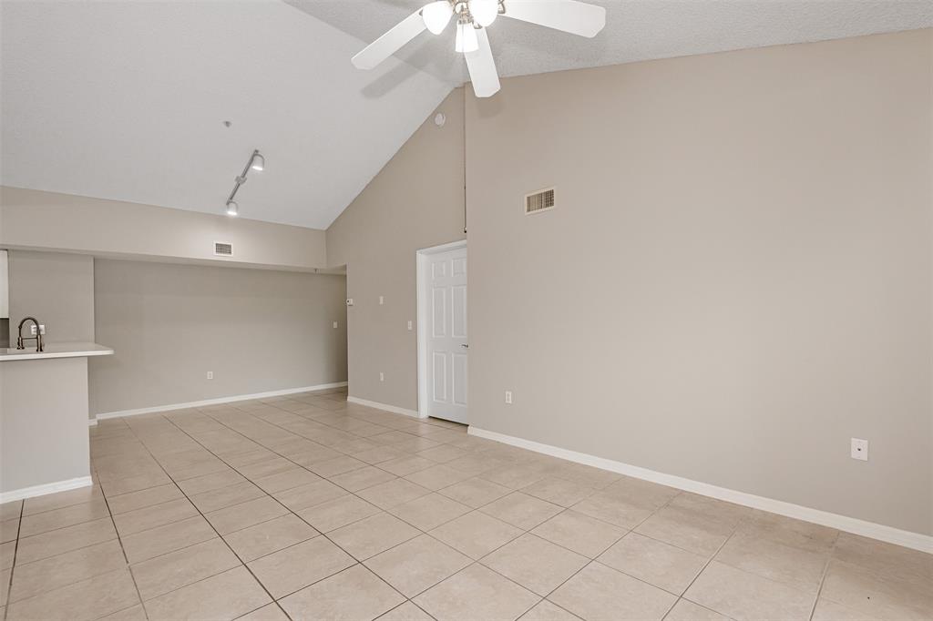 3848 Lyons Road, Unit 202 Coconut Creek, FL 33073 - Photo 8 of 32 an empty room with a ceiling fan and carpet