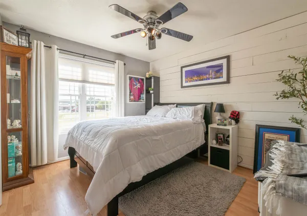 a bedroom with a bed and a chandelier