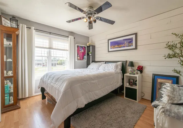 a bedroom with a bed and a chandelier