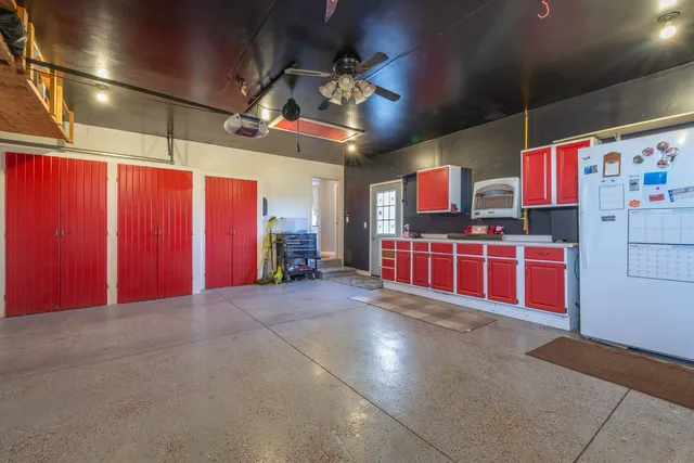 a view of an empty room with window and cabinet
