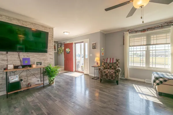 a living room with furniture fireplace and flat screen tv