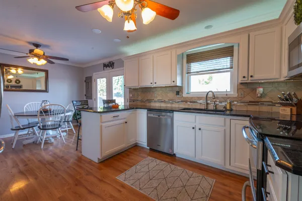 a kitchen with a sink cabinets and window