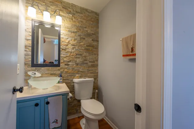 a bathroom with a toilet a sink and mirror
