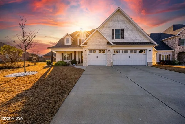 a view of a white house with a yard
