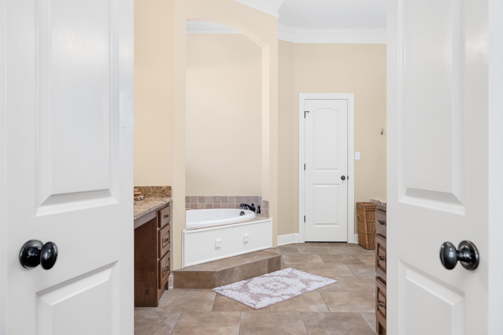 104 Eagle Trace Road Covington, TN 38019 - Photo 38 of 40 Full bathroom featuring vanity, a garden tub, and ornamental molding