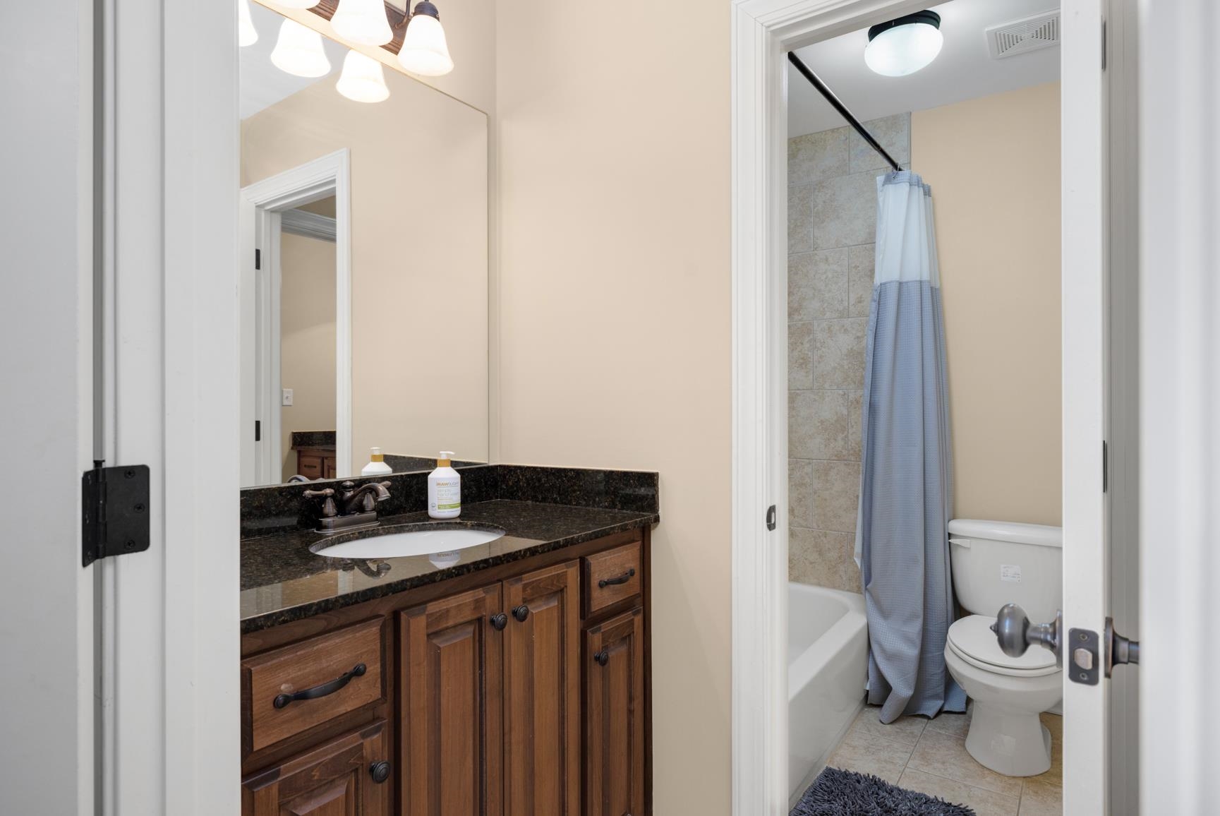 104 Eagle Trace Road Covington, TN 38019 - Photo 26 of 40 a bathroom with a granite countertop sink toilet and shower
