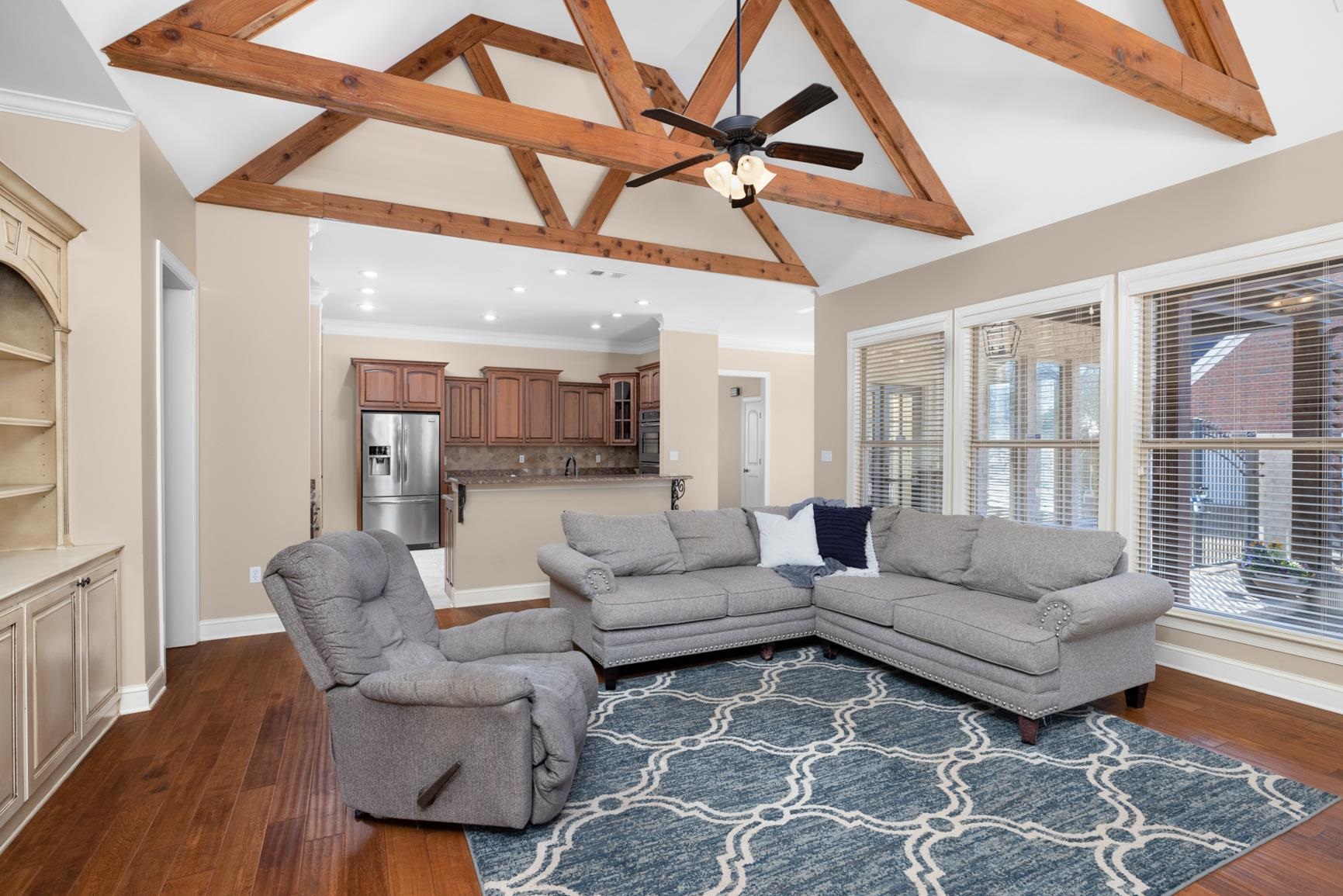 104 Eagle Trace Road Covington, TN 38019 - Photo 3 of 40 Living room with ceiling fan, crown molding, dark wood finished floors, lofted ceiling, and recessed lighting