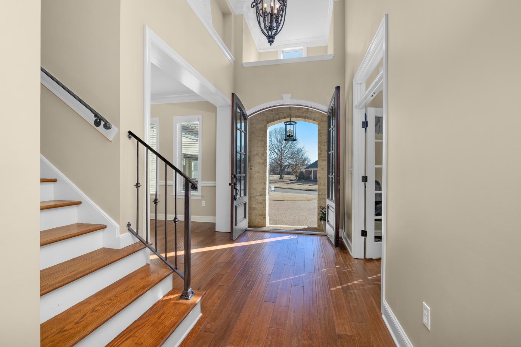 104 Eagle Trace Road Covington, TN 38019 - Photo 7 of 40 Foyer entrance with crown molding, a chandelier, dark wood-style floors, and a high ceiling
