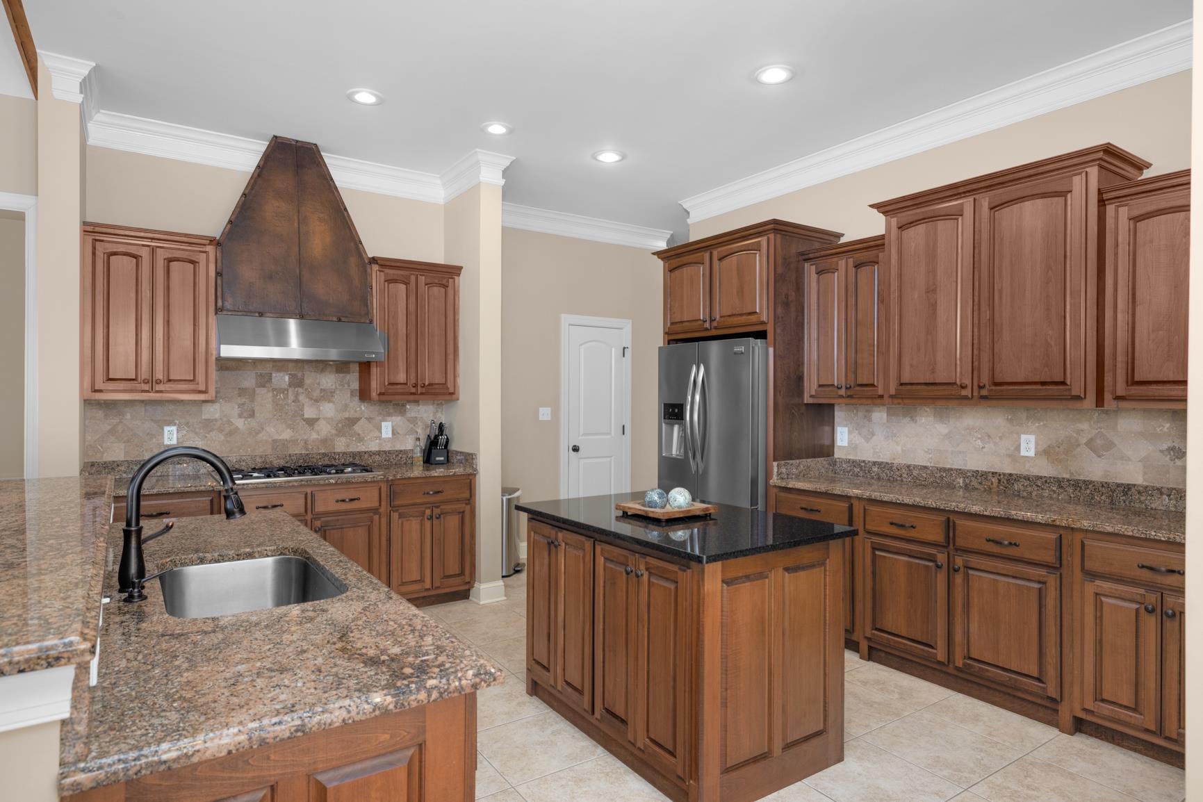 104 Eagle Trace Road Covington, TN 38019 - Photo 8 of 40 a kitchen with kitchen island granite countertop a sink stove and refrigerator