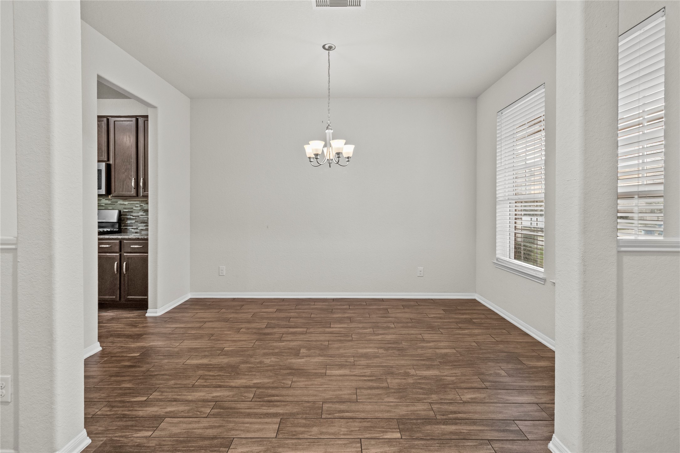 14610 Ruddy Duck Lane Houston, TX 77049 - Photo 7 of 24 wooden floor in an empty room with a window