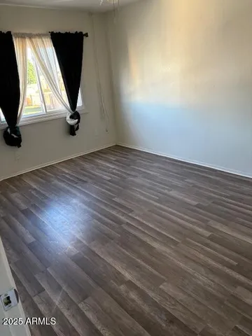 a view of a room with wooden floor