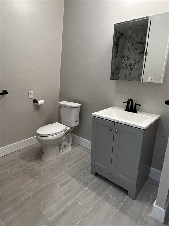 56 Pelham Street Methuen, MA 01844 - Photo 11 of 27 a bathroom with a toilet sink and mirror