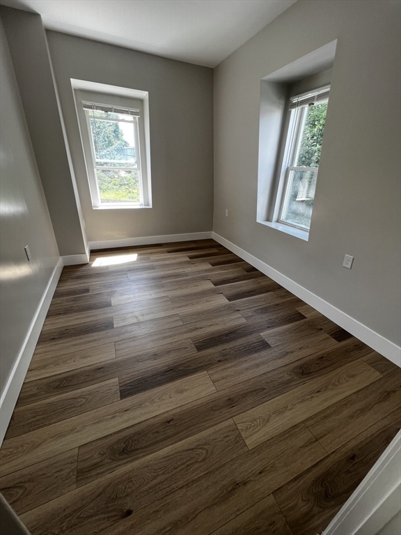 56 Pelham Street Methuen, MA 01844 - Photo 16 of 27 a view of an empty room with wooden floor and a window