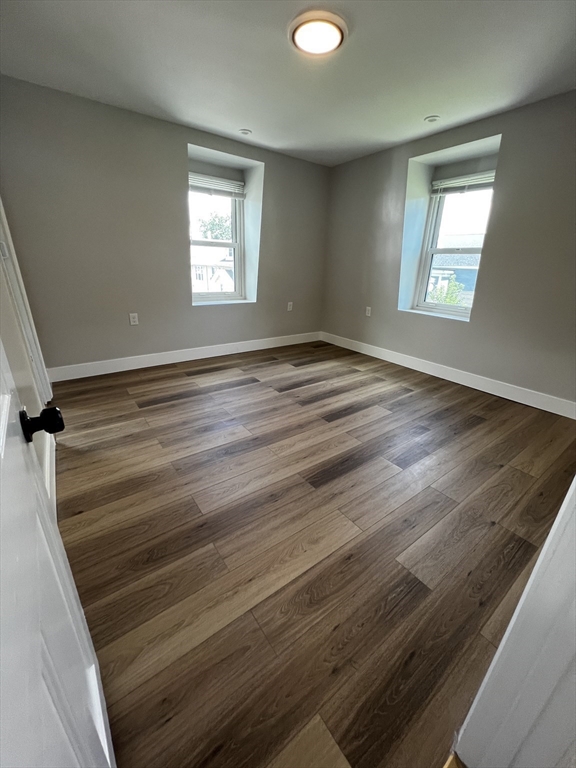 56 Pelham Street Methuen, MA 01844 - Photo 17 of 27 an empty room with wooden floor and windows