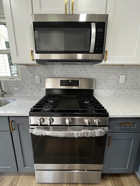 56 Pelham Street Methuen, MA 01844 - Photo 3 of 27 a stove top oven sitting inside of a kitchen