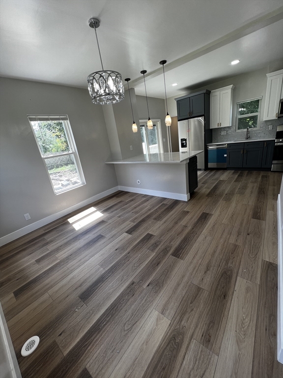 56 Pelham Street Methuen, MA 01844 - Photo 5 of 27 a view of a kitchen with a sink wooden floor and cabinets