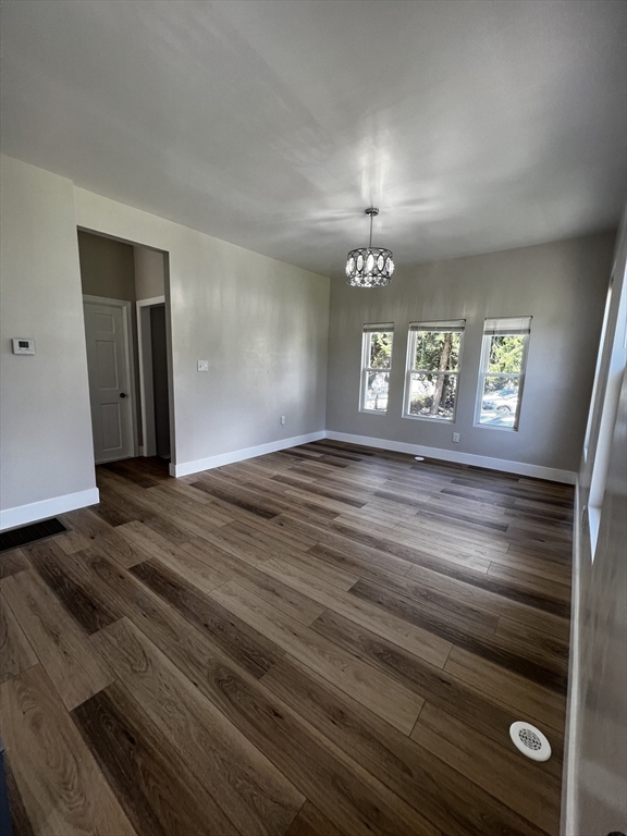 56 Pelham Street Methuen, MA 01844 - Photo 7 of 27 a view of an empty room with wooden floor and a window