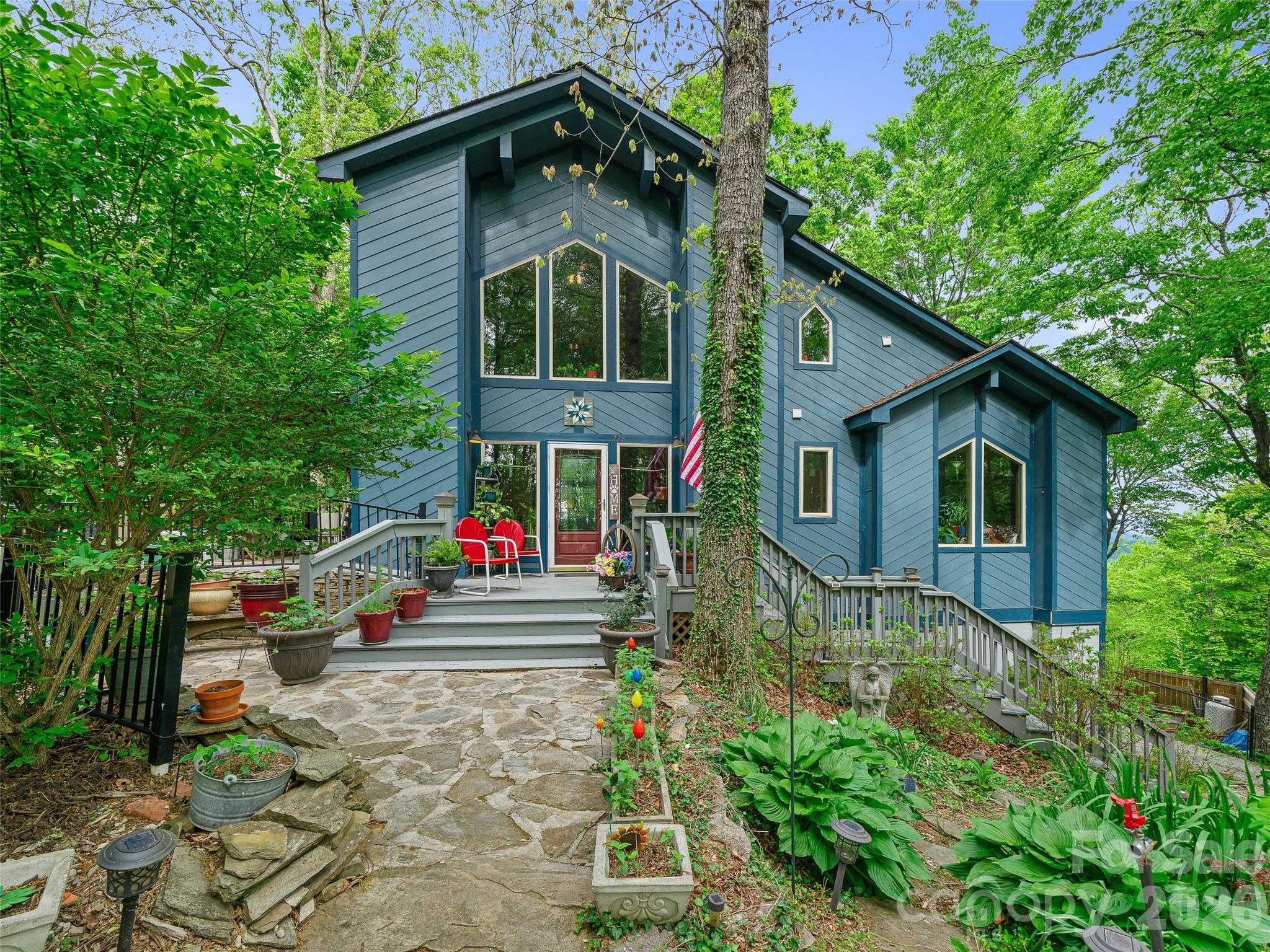 228 Continental Divide Road Spruce Pine, NC 28777 - Photo 1 of 48 a front view of a house with small garden