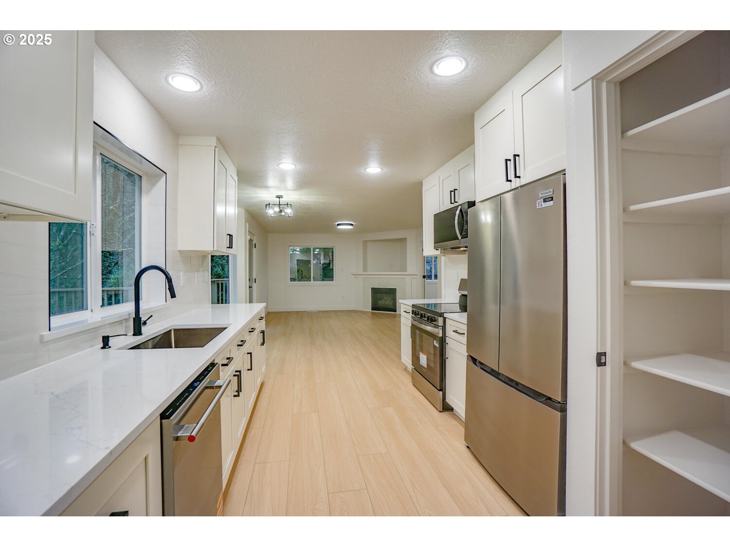 3704 Northwest Orchard Court Camas, WA 98607 - Photo 6 of 33 a kitchen with stainless steel appliances a refrigerator sink and stove