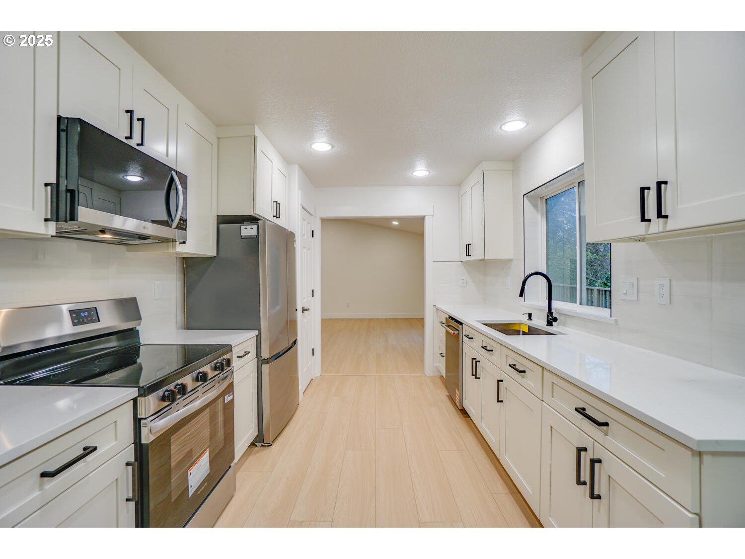 3704 Northwest Orchard Court Camas, WA 98607 - Photo 7 of 33 a kitchen with stainless steel appliances a sink stove top oven and refrigerator