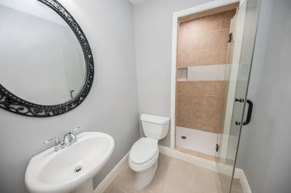 a bathroom with a toilet sink and a mirror