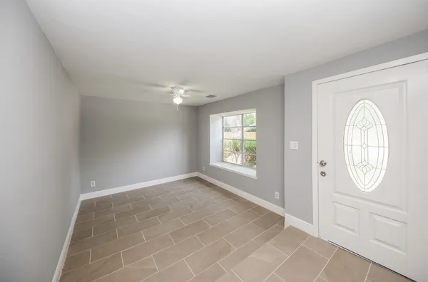an empty room with windows mirror and windows