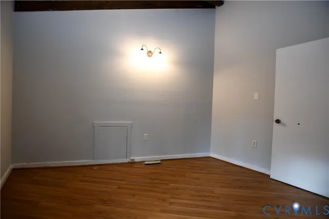 a view of an empty room and wooden floor