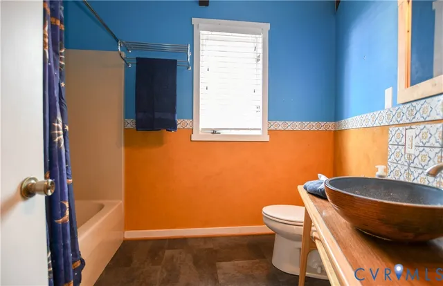 a bathroom with a toilet and a sink