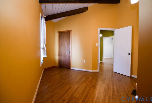 a view of hallway with wooden floor
