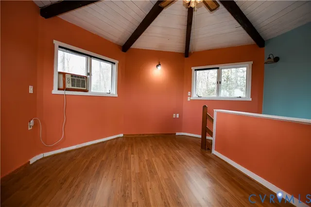 a view of room with window and wooden floor