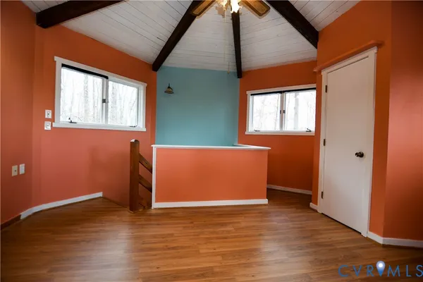a view of a room with wooden floor and window