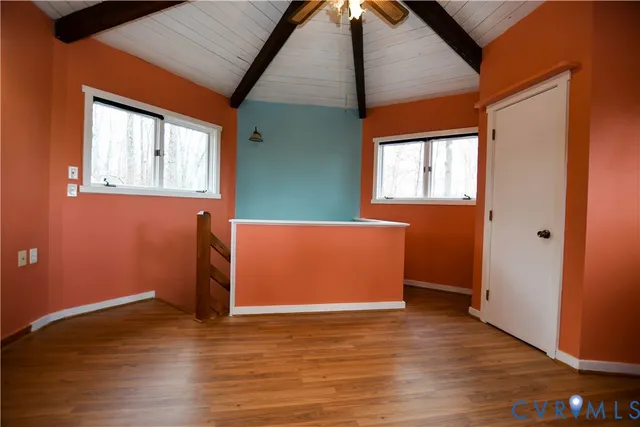 a view of a room with wooden floor and window