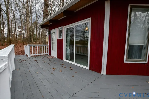 a view of backyard with deck and outdoor seating