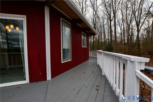 a view of a house with backyard and deck