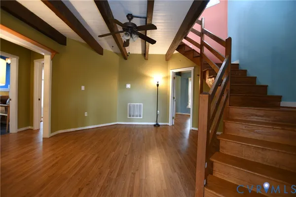 a view of staircase with railing and white walls