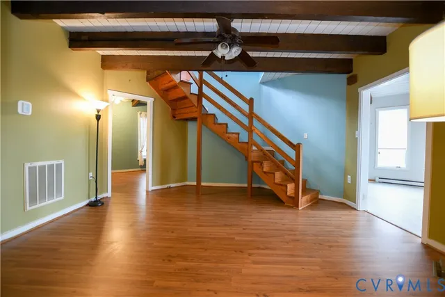a view of an entryway with wooden floor