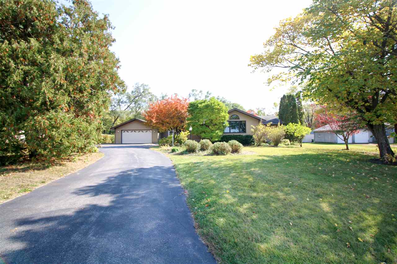 14031 South Bluff Road Rockton, IL 61072 - Photo 1 of 38 a view of a yard with plants and trees