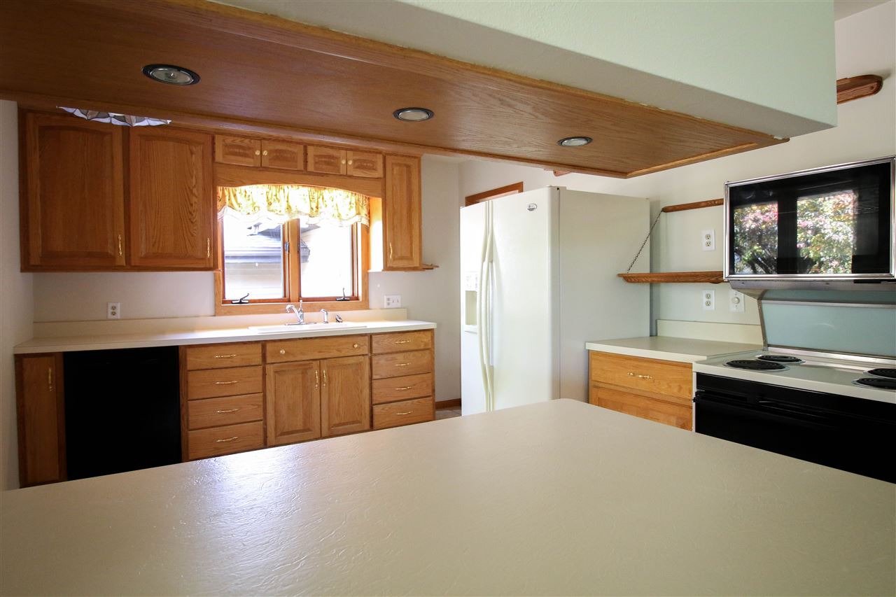 14031 South Bluff Road Rockton, IL 61072 - Photo 6 of 38 a kitchen with granite countertop a refrigerator and a sink