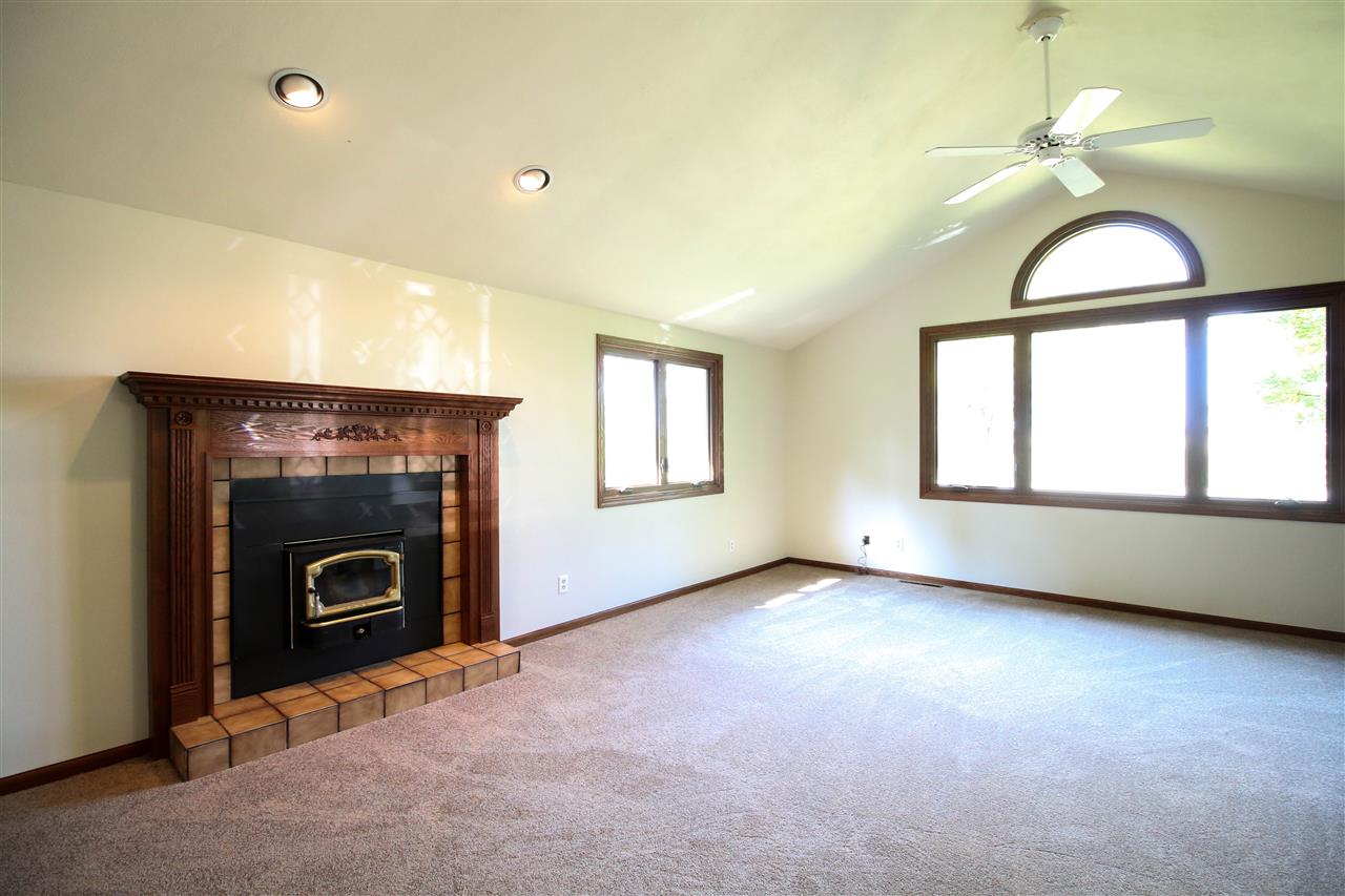 14031 South Bluff Road Rockton, IL 61072 - Photo 8 of 38 an empty room with windows and fireplace