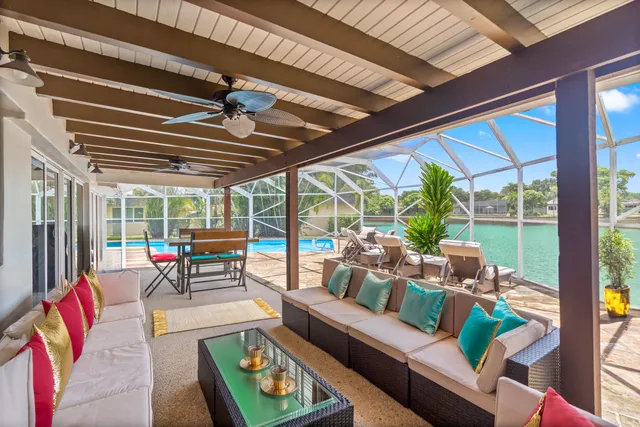 a living room with furniture and a floor to ceiling window