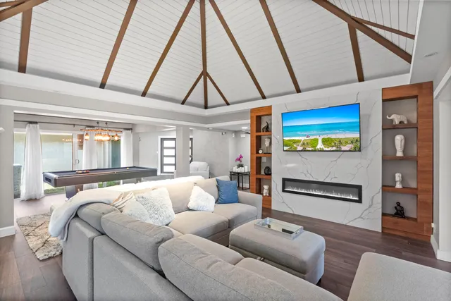 a living room with a flat screen tv and a large window