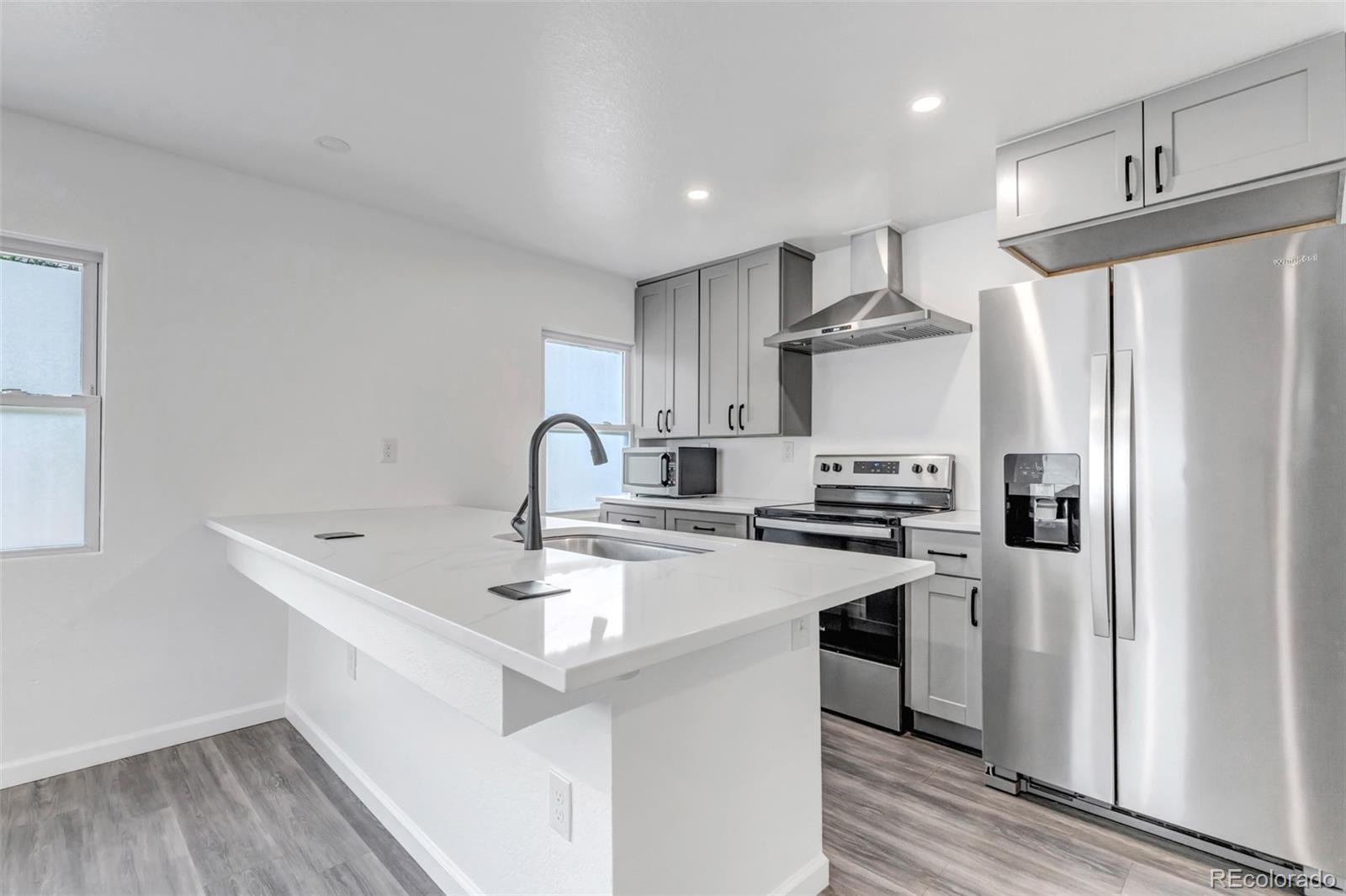 10 South Irving Street Denver, CO 80219 - Photo 11 of 35 a kitchen with stainless steel appliances a refrigerator sink and stove