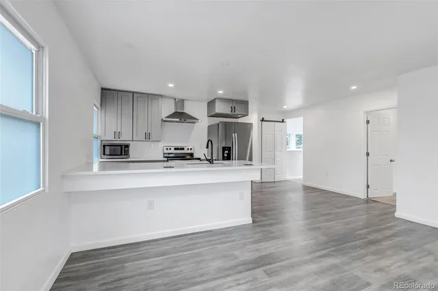 a view of kitchen with wooden floor