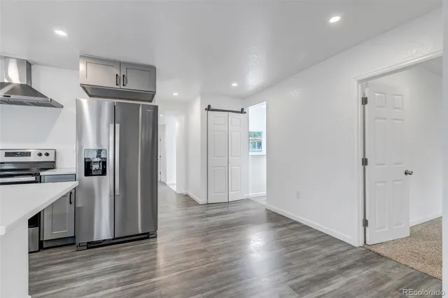 a view of a refrigerator in kitchen and wooden floor