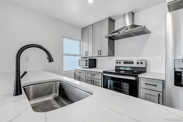 a kitchen with granite countertop a stove and a sink