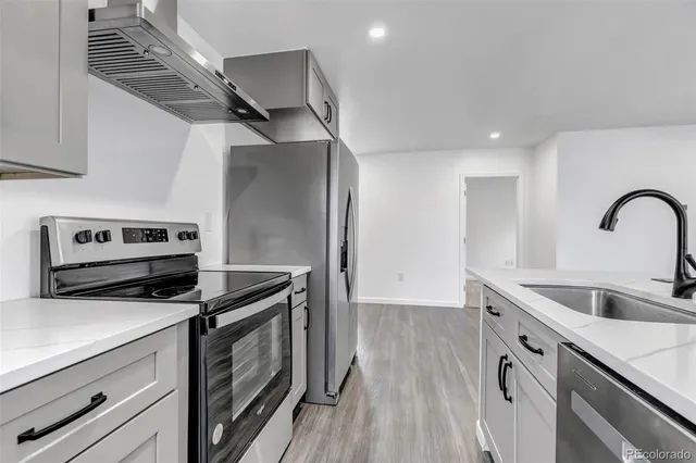 a kitchen that has a sink and a stove