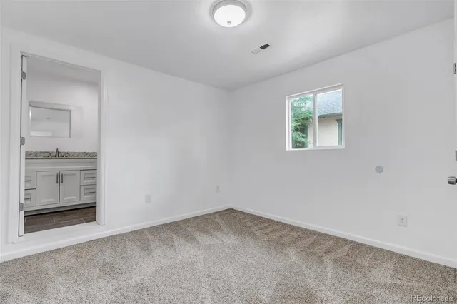 an empty room with windows and entrance