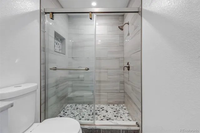 a bathroom with a shower toilet and a sink