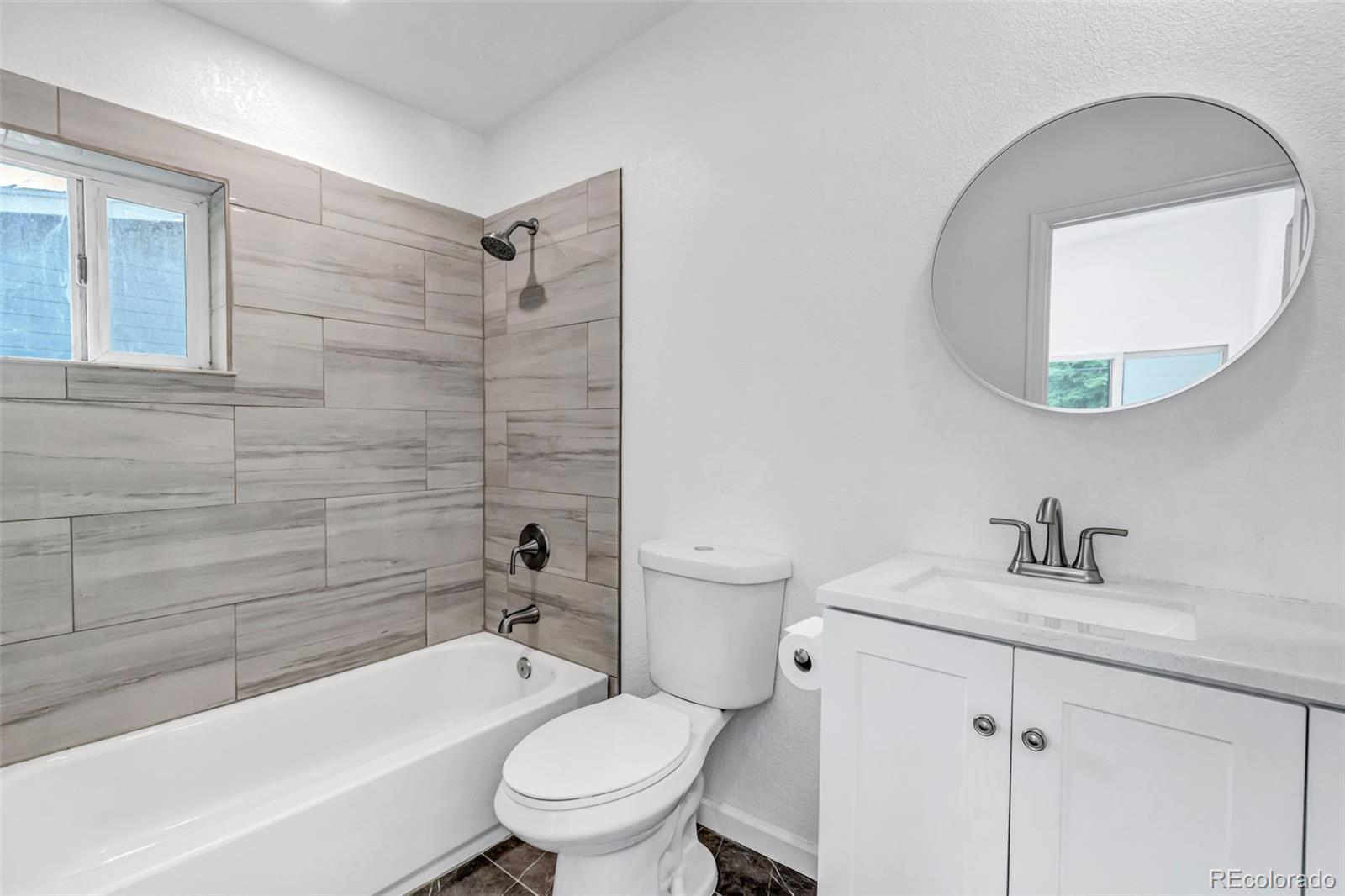 10 South Irving Street Denver, CO 80219 - Photo 28 of 35 a bathroom with a sink toilet and shower