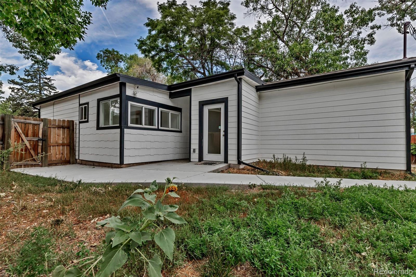 10 South Irving Street Denver, CO 80219 - Photo 30 of 35 a front view of a house with a yard and garage